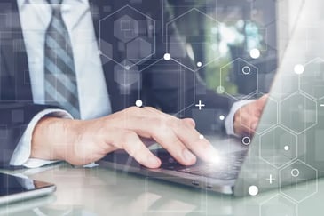 Female insurer using laptop in modern office